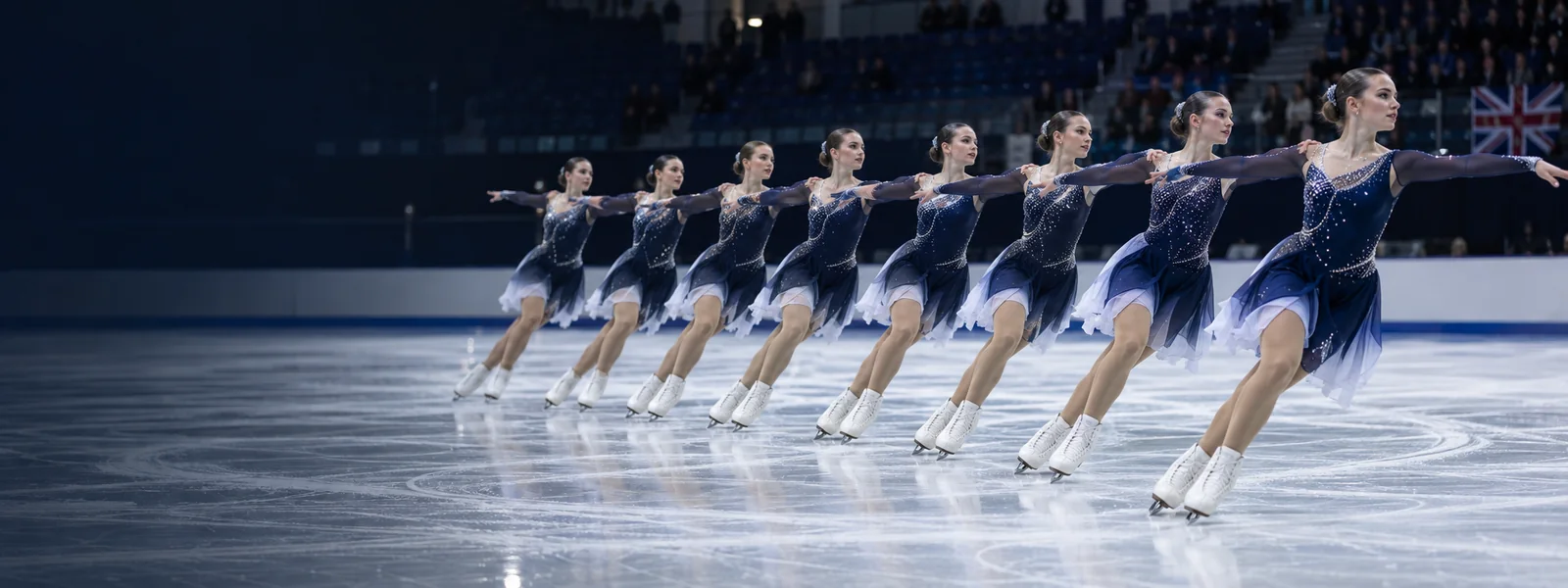 Synchronised skaters gliding together in formation on the ice